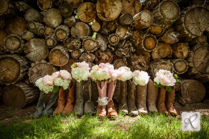 the bride's bouquets are lined up in boots