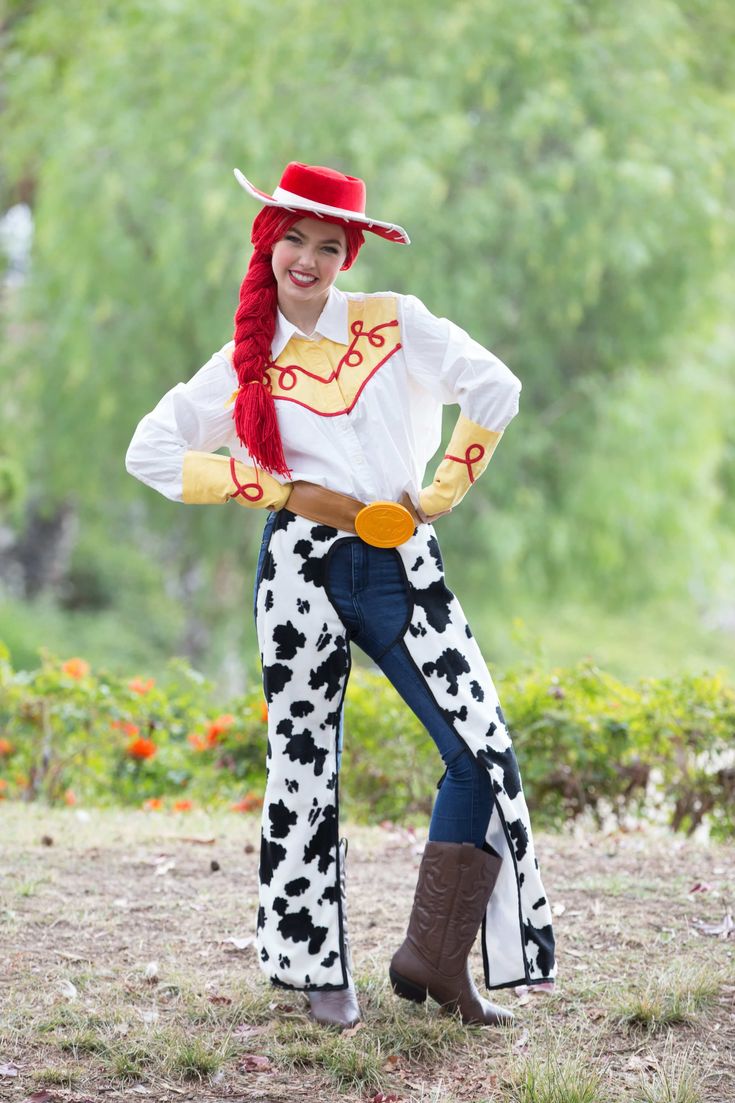 a woman in a cowgirl costume posing for a photo with her hands on her hips