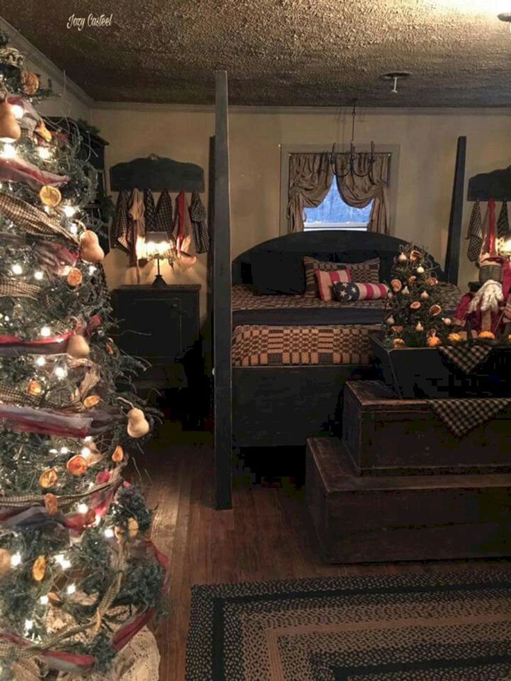 a christmas tree in the corner of a room next to a bed and dressers