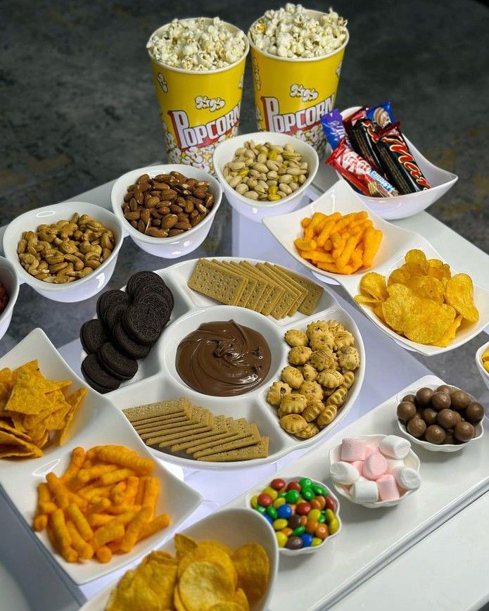 a table topped with bowls filled with different types of snacks