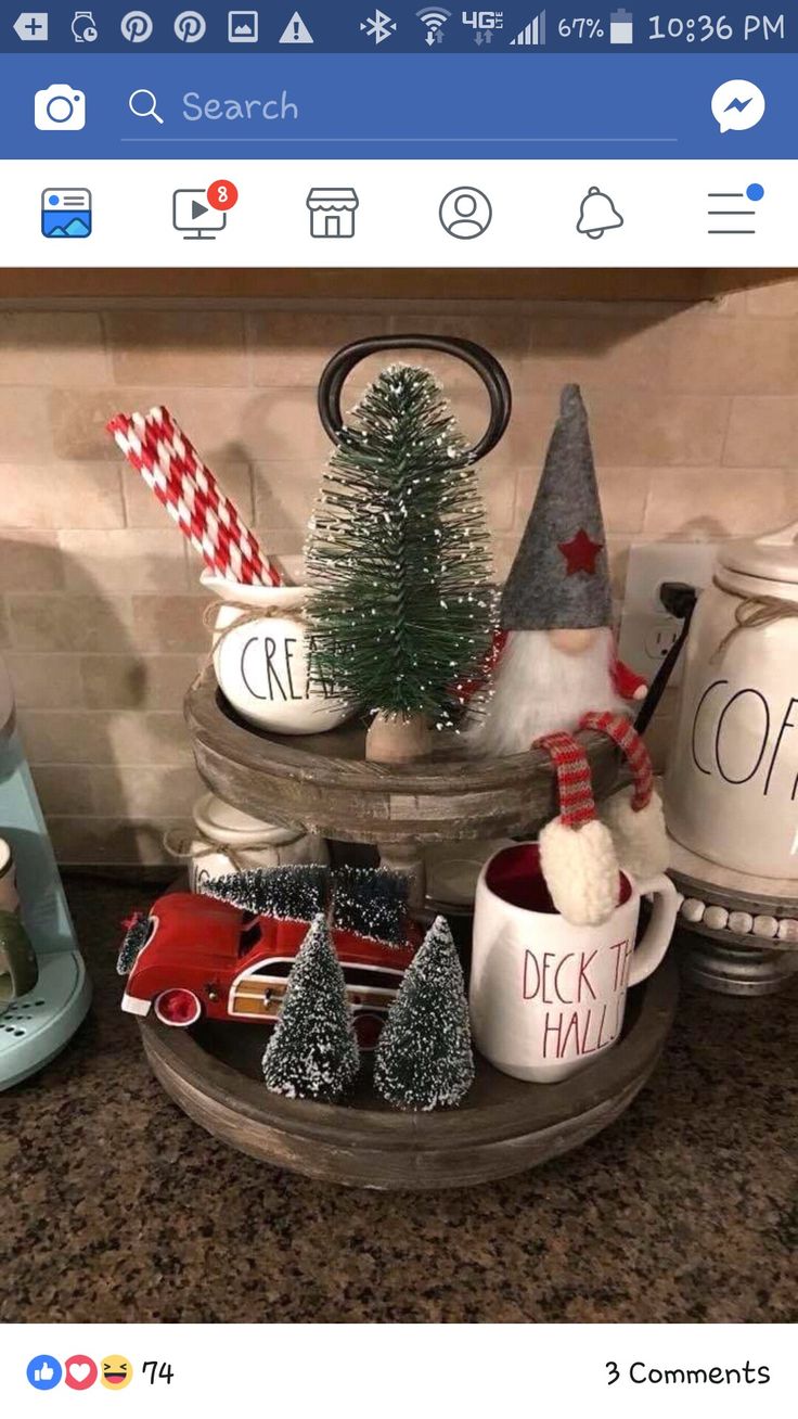 some christmas decorations are sitting on top of a kitchen counter with coffee cups and mugs