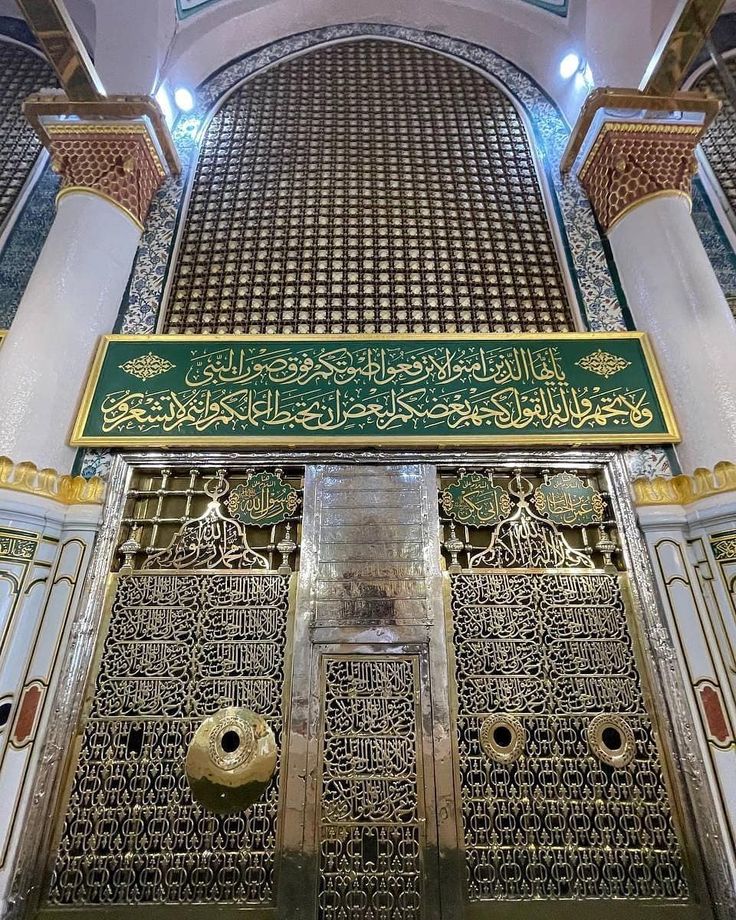 the inside of an ornate building with gold and green decorations on it's doors