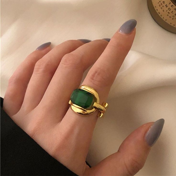 One of a kind, the Marie Green Gem ring is featured with polished 925 sterling silver plated in real 18K gold. It exudes an elegant, vintage retro aurora that will make any style a distinctive statement. Details 18K Gold Plated on 925 Sterling Silver with green stone Size: Open and adjustable Delivered in Poppy Mae custom jewelry boxes ready to be gifted Avoid contact with any chemicals or alcohol. Please refer to our care guide for more details. Chic Rings, Green Stone Rings, Gold Color Ring, Party Rings, Green Gems, Stone Gold, Green Gemstones, Bride Jewellery, Green Stone