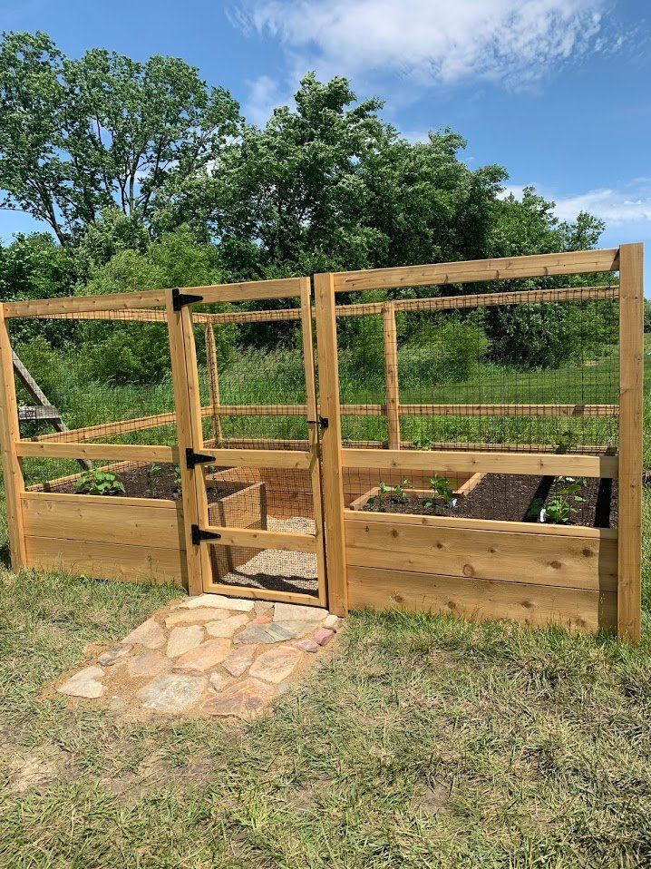 an outdoor garden area with raised wooden planters