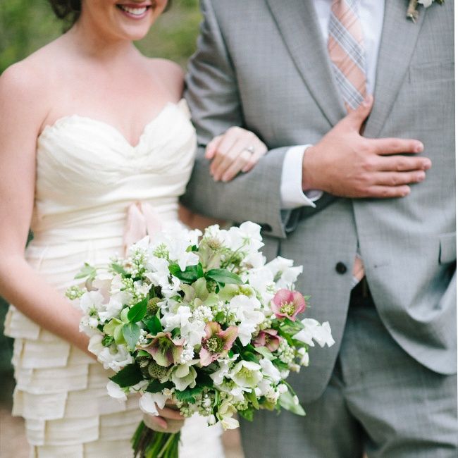 the bride and groom are holding their bouquets