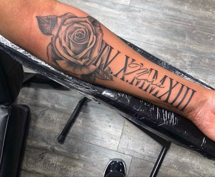 a man's arm with a rose tattoo on it and the words william written in cursive font