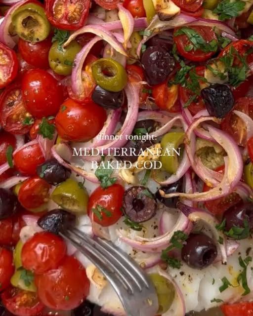 a salad with tomatoes, onions and olives