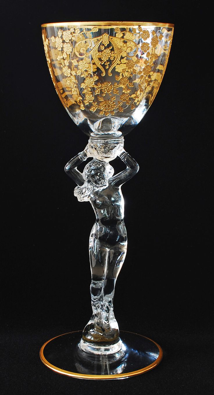 an ornate glass goblet on a black background