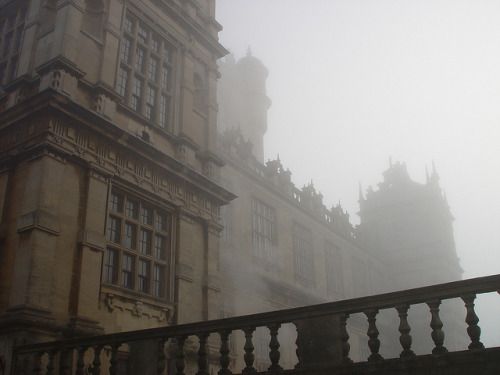 an old building is shown in the fog