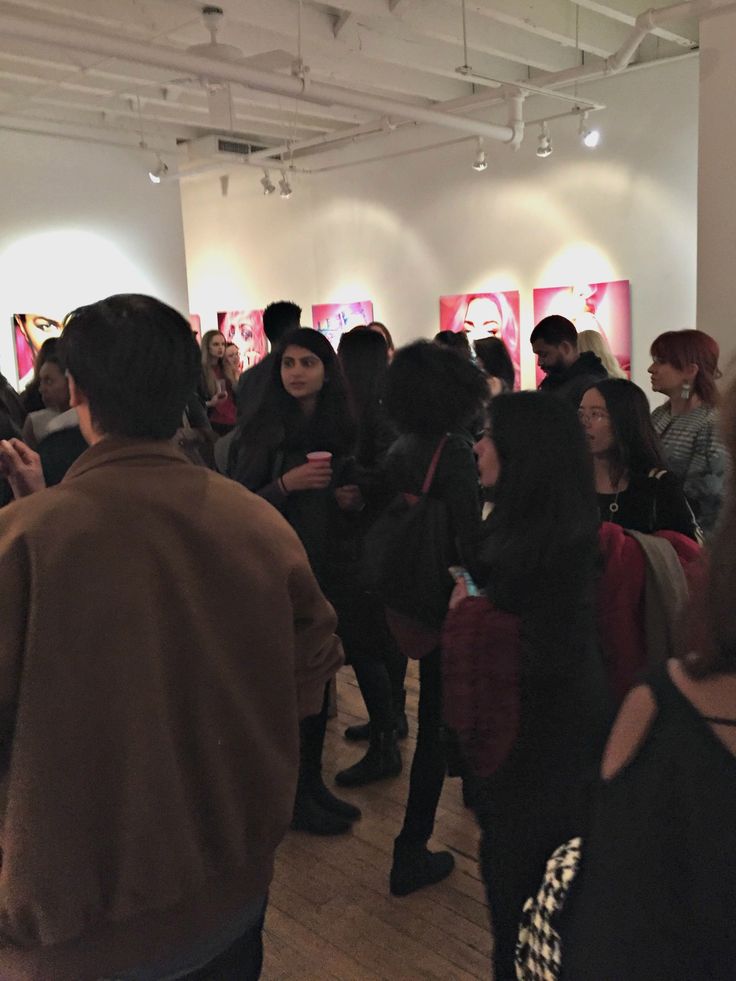 a group of people standing around in a room