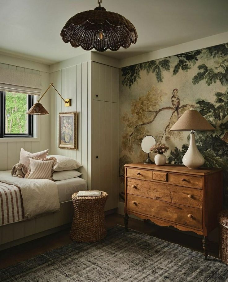 a bed room with a neatly made bed next to a dresser and lamps on top of it