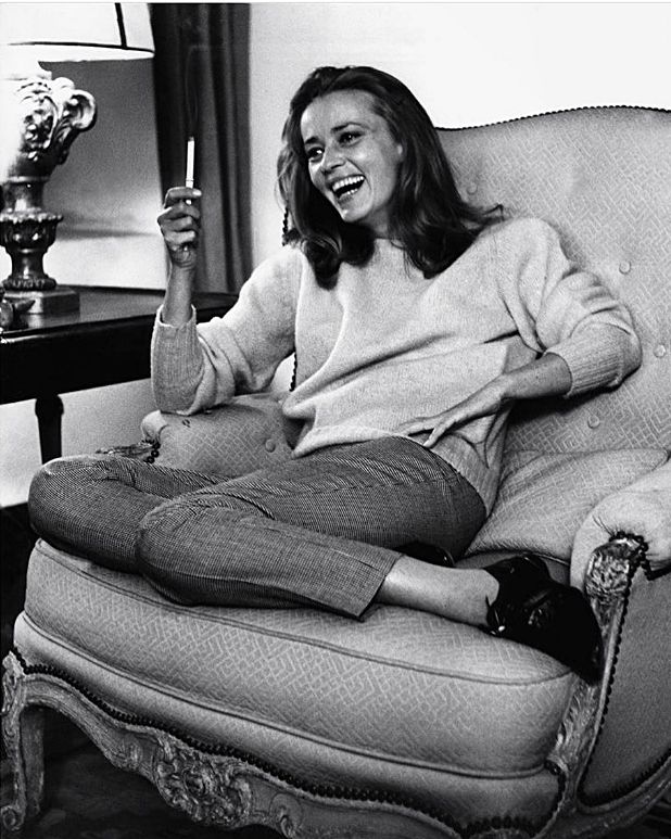 a black and white photo of a woman sitting in a chair