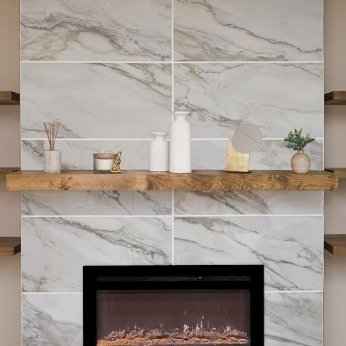 a fireplace in a living room with marble walls and shelving above the fire place