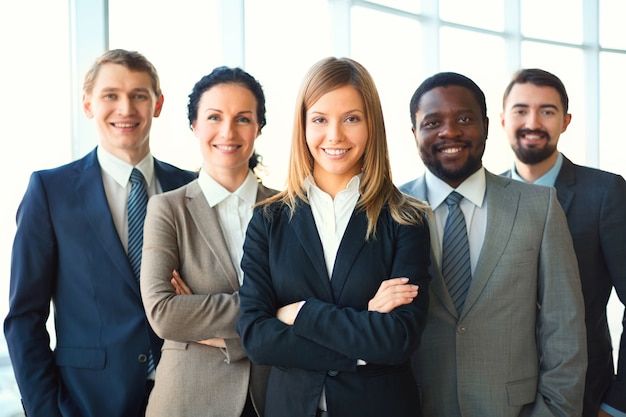 a group of business people standing next to each other in front of a white background