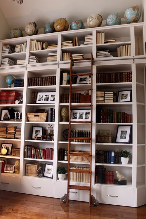 a ladder leaning against a bookshelf filled with lots of books