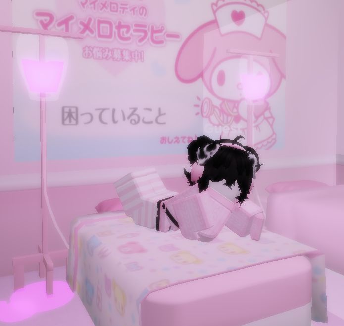 a small black dog standing on top of a bed in a room with pink walls