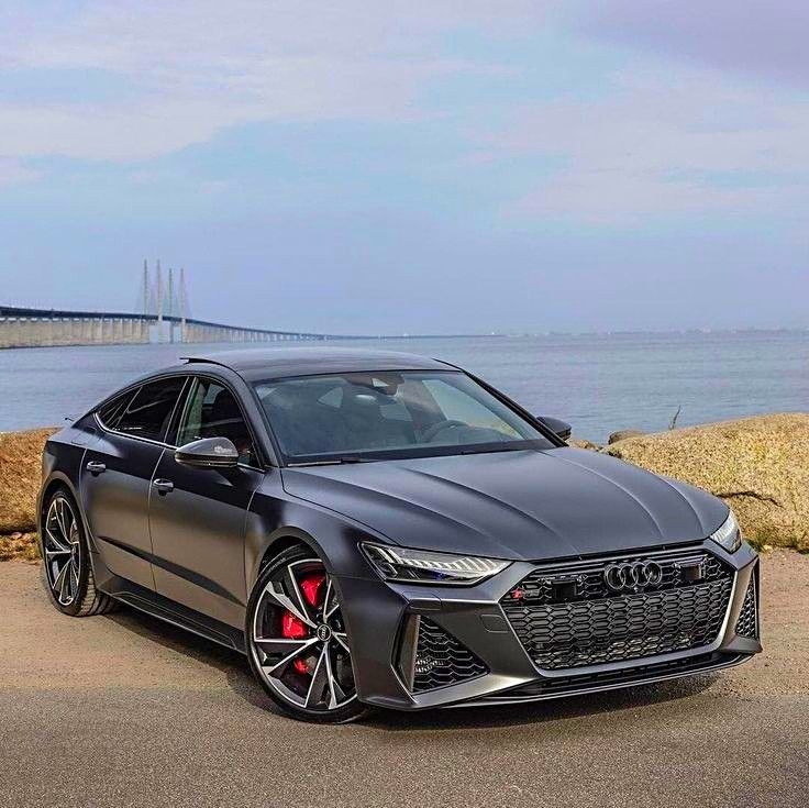 the new audi rs coupe is parked by the water