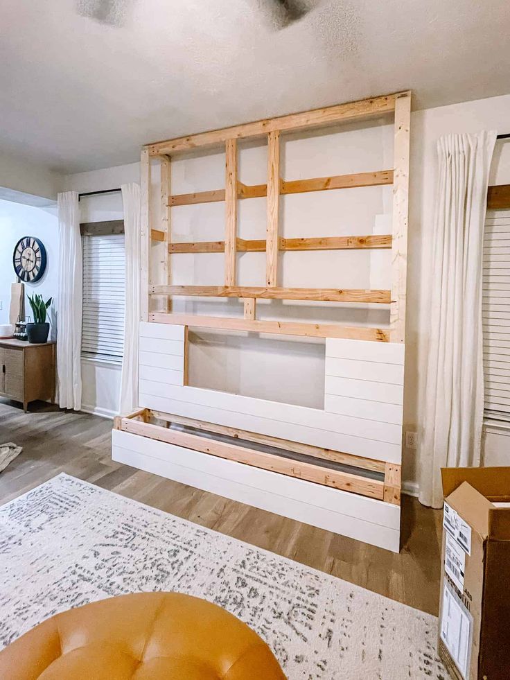 a living room with white walls and wooden furniture