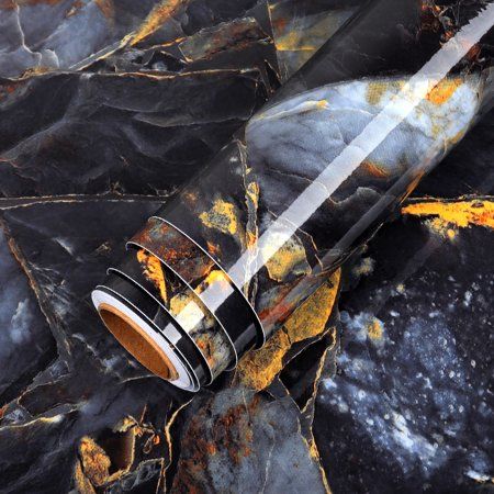 an artistic photo of a glass bottle on some black rocks with yellow spots and rust