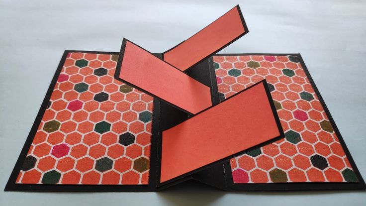 an open book with three pieces of paper cut out to look like hexagons