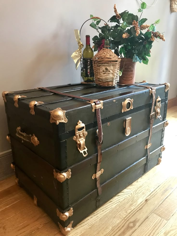 two trunks are stacked on top of each other with plants in the middle one is empty