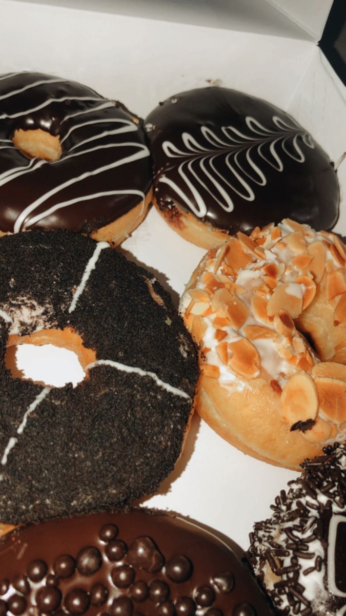 a box filled with lots of different types of donuts