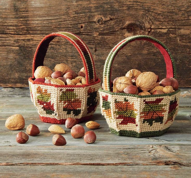 two baskets filled with nuts sitting on top of a wooden table