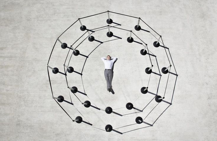 a man standing in the middle of a circle with many balls and arrows on it