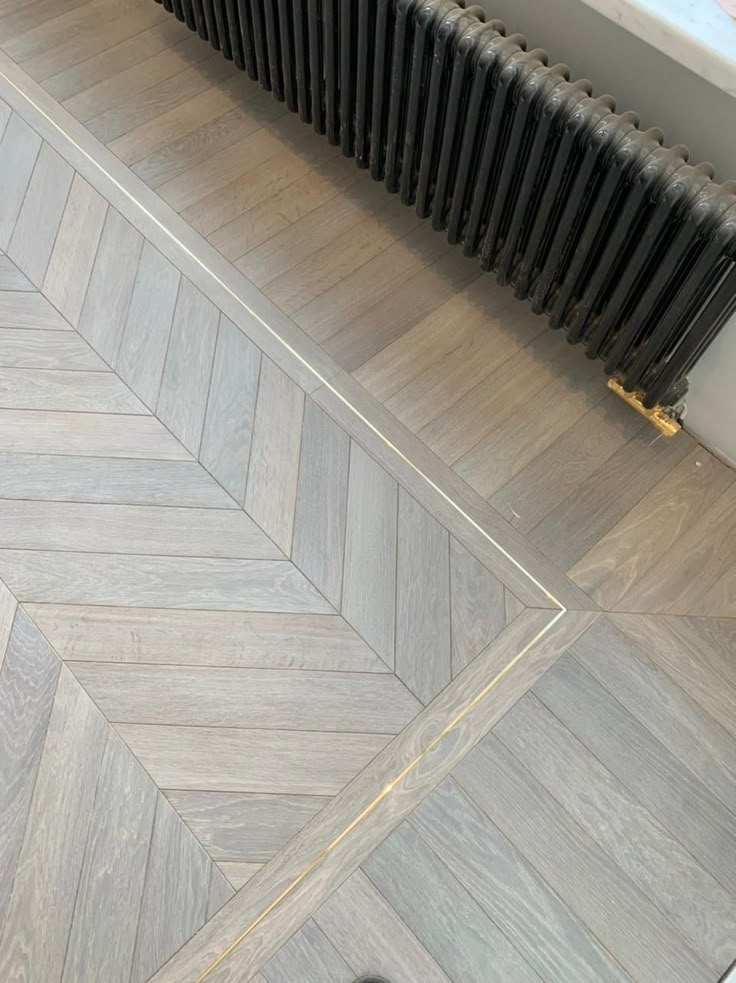 a radiator sitting on top of a wooden floor next to a radiator