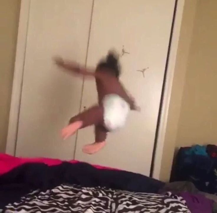 a person jumping in the air on a bed