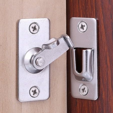 a close up of a door handle on a wooden door with metal latch and bolt