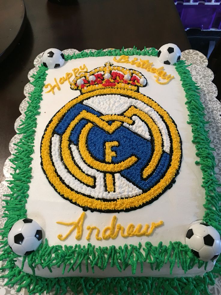 a birthday cake with soccer balls and the name of an official team is on display