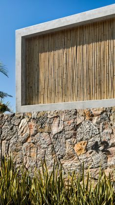 a stone wall with wooden slats on it