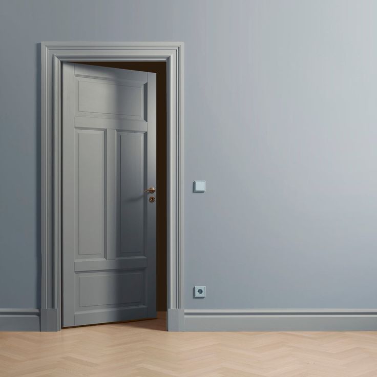 an open door in a empty room with parquet floor and wall paint color on the walls