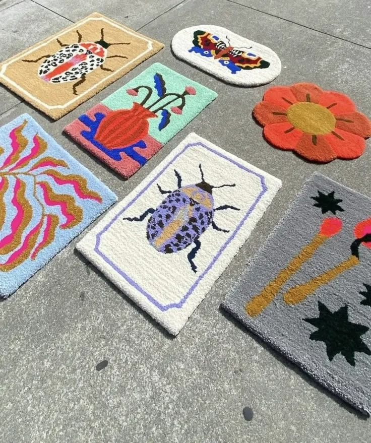 four different rugs on the ground with flowers and bugs