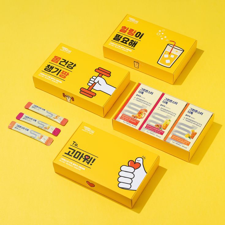 three boxes with stickers on them sitting on a yellow surface