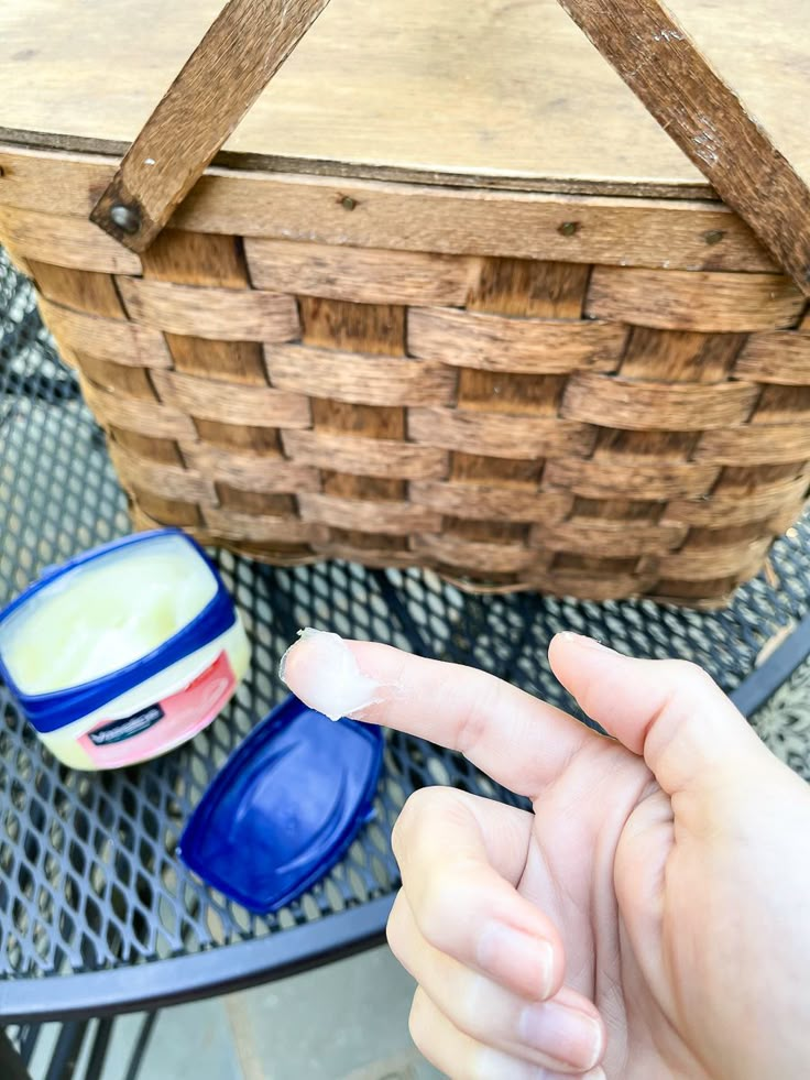 a person pointing at something in front of a basket