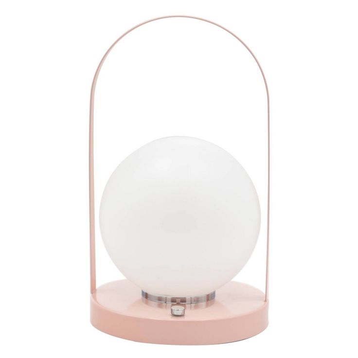 a white ball sitting on top of a pink stand