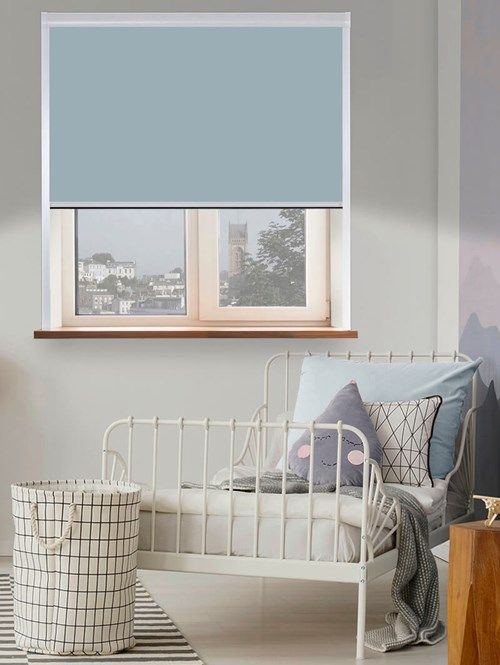 a white bed sitting under a window in a bedroom