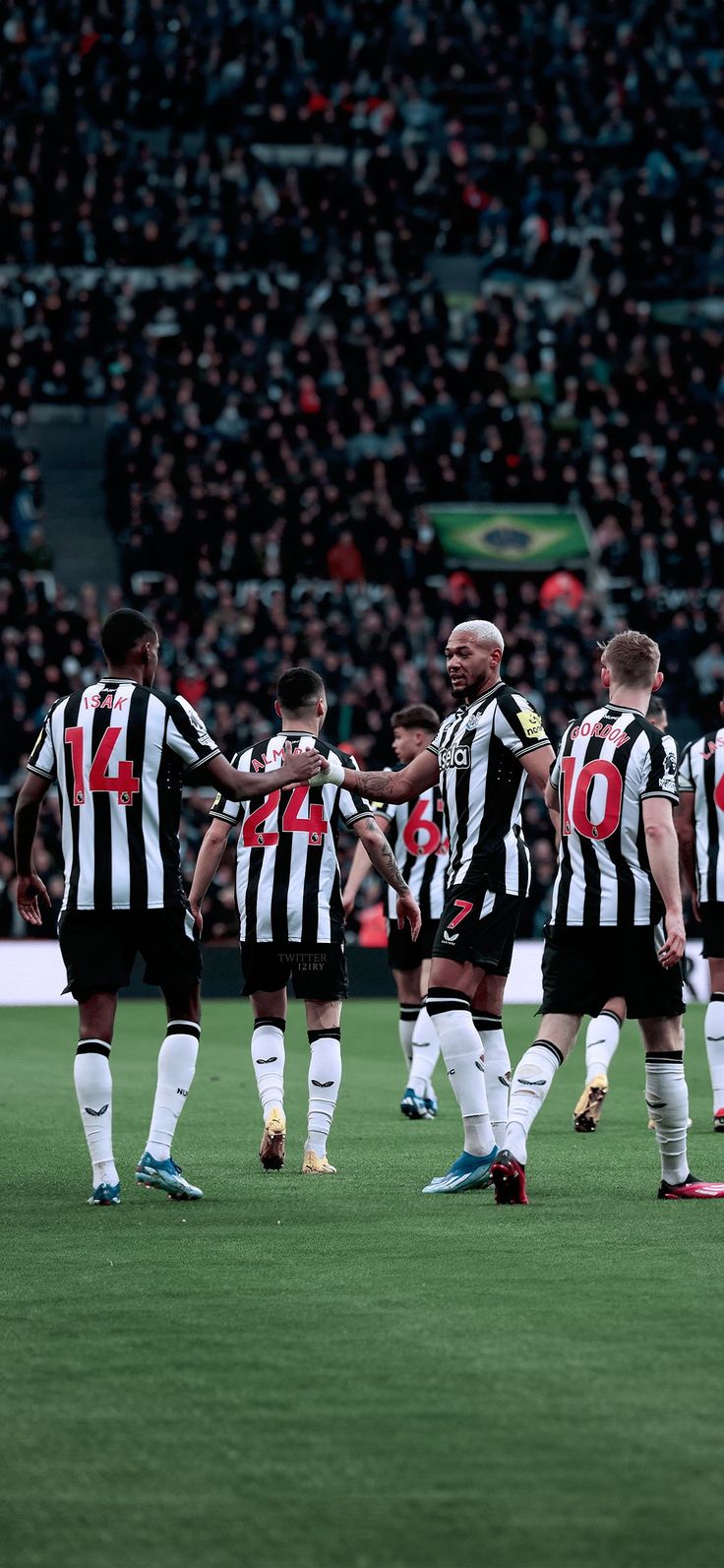 a group of men standing on top of a soccer field