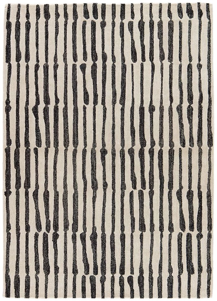 a black and white rug with vertical lines on the ground, in front of a white background