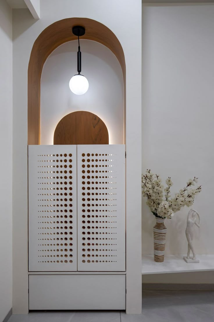 a white room with a wooden door and some vases