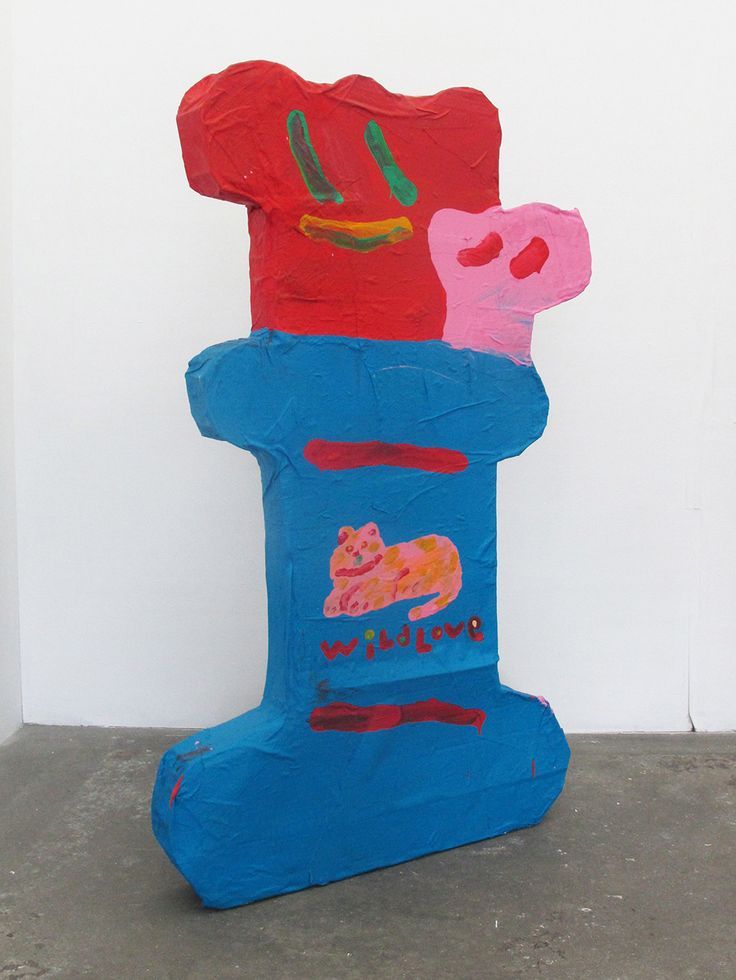 a blue sculpture with three different colored images on it