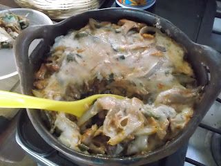 a pan filled with food sitting on top of a stove