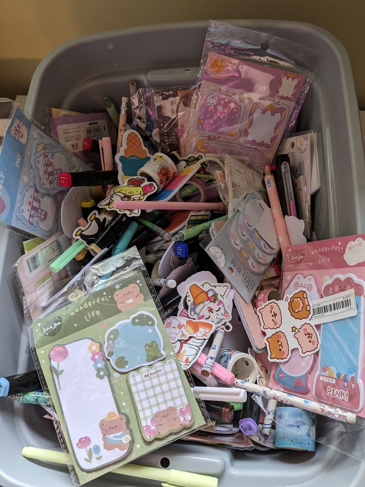 a plastic container filled with lots of stationary items