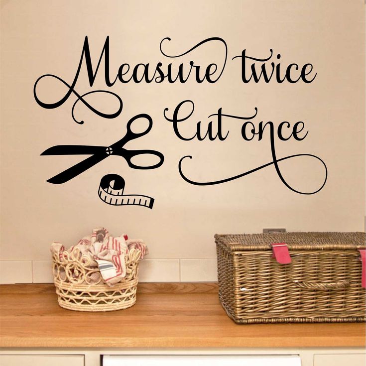 a wall decal with the words measure twice and cut on it's side