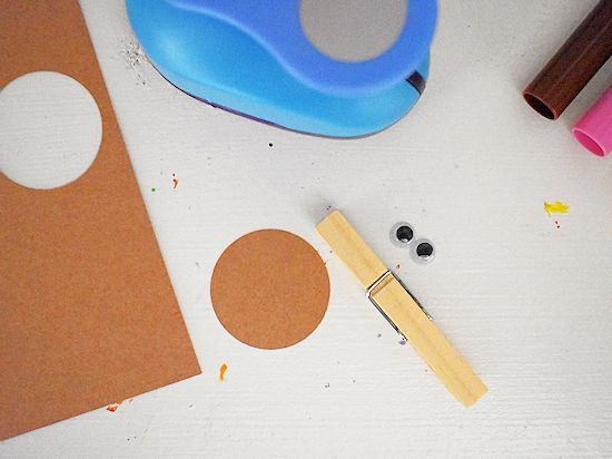 some crafting supplies are laying out on the table, including scissors and paper circles