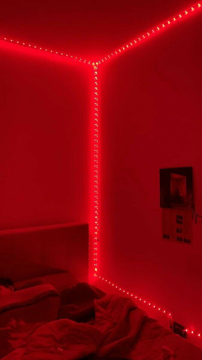 a bed with red lights in a room