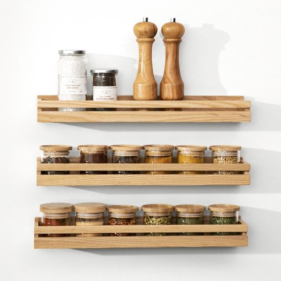 two wooden shelves with spice jars on them