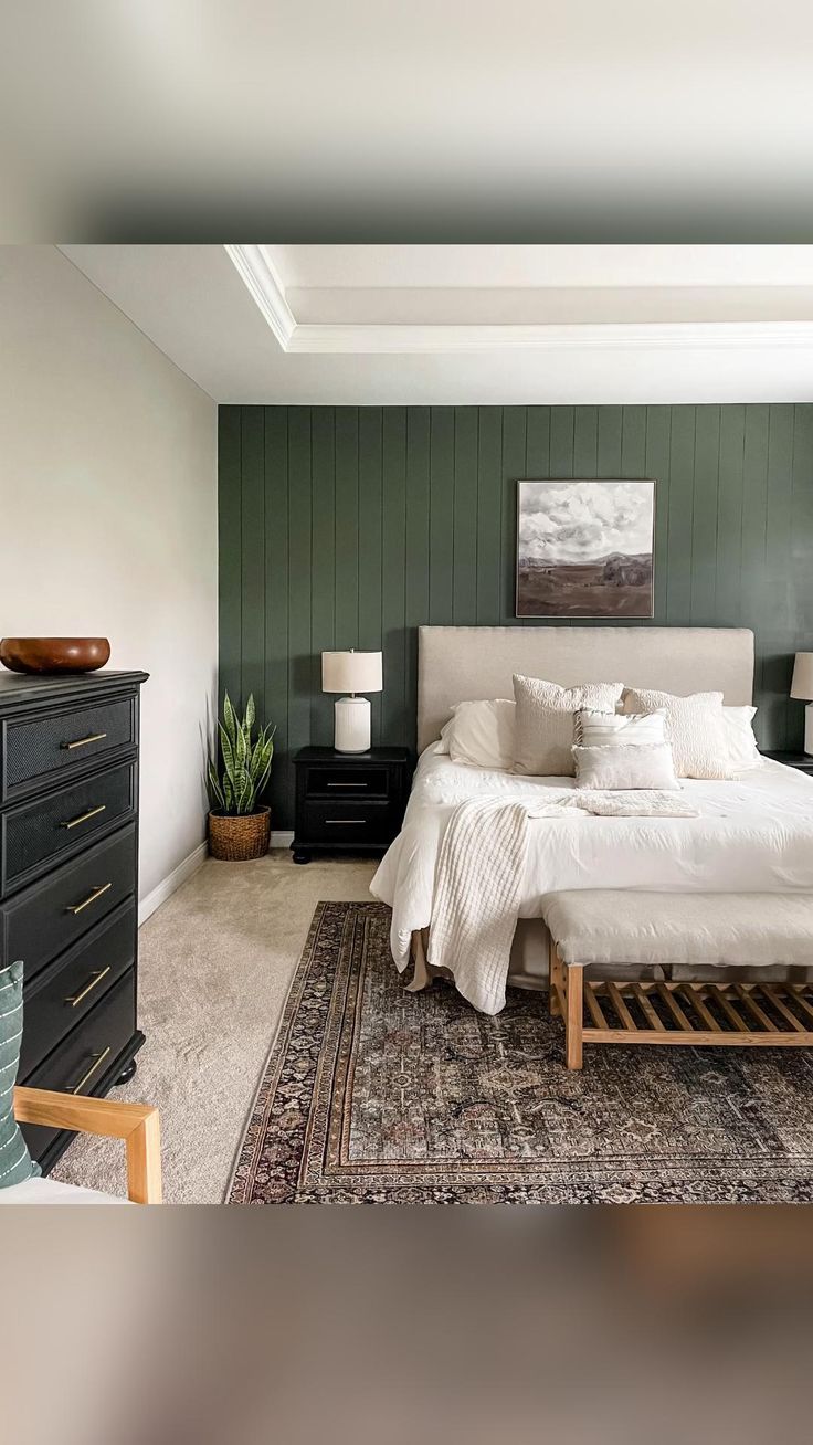 a bedroom with green walls and white bedding